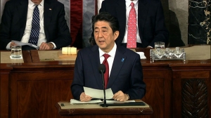 Japan’s prime minister honors US deaths in WWII; no apology for sex slaves